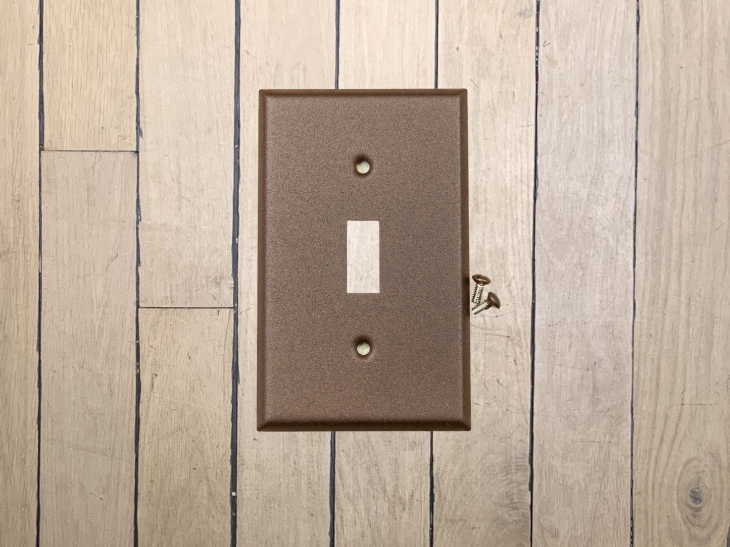 Walnut Texture powder coated Toggle, Rocker, Duplex, and Blank standard size metal switch plates.  Dark brown outlet cover